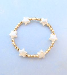 pearl star 14k fill beaded bracelet Beaded Bracelets With Star Charm For Gifts, Hypoallergenic 14k Gold Filled Star Jewelry, Gold Bracelets With Star Charm And Round Beads, White Jewelry With Star Charm And Round Beads, White Beaded Bracelets With Star Charm As Gift, White Beaded Bracelet With Star Charm For Gift, White Beaded Bracelets With Star Charm For Gift, White Star-shaped Handmade Jewelry, Handmade White Star Jewelry