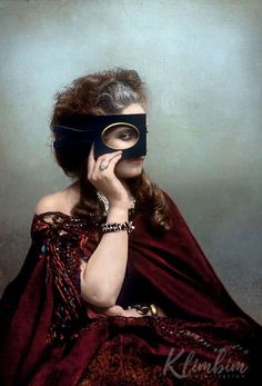 a woman in a red dress holding a black mask over her face