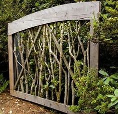 an old wooden gate is surrounded by greenery