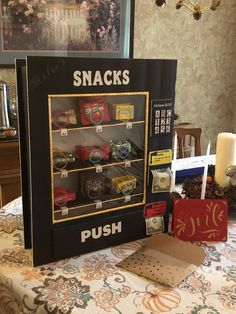 there is a display case with snacks in it on the table next to some candles