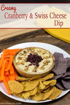 cranberry and swiss cheese dip on a plate with crackers and carrots