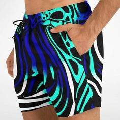 Dive into summer with confidence and style in our Maris Equi Men's Angelfish Swim Shorts. Crafted for both comfort and performance, these swim trunks are the perfect companion for your beach adventures. Pair them with our matching shirts, flip flops, and swim briefs for a coordinated look that's sure to turn heads. Explore our collection now and make a splash this season! These swim trunks are handmade after you order them. Please allow 2 weeks for delivery. This suit has a lot of stretch and is Blue Beachwear Athletic Shorts For Summer, Casual Surfing Athletic Shorts For Summer, Casual Summer Surfing Athletic Shorts, Casual Summer Swimwear For Water Sports, Green Athletic Shorts For Beach Season Vacation, Blue Swim Trunks For Summer Swimming, Tropical Style Swim Trunks For Summer Sports, Black Summer Swim Trunks For Surfing, Blue Summer Swim Trunks For Swimming