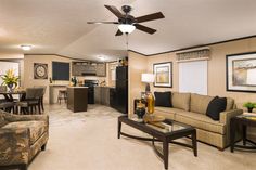 a living room filled with furniture and a ceiling fan