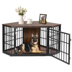 a dog is sitting in its caged kennel with flowers on the table next to it