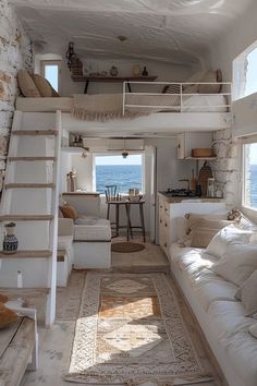 a living room filled with furniture next to the ocean