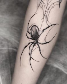 a black and white photo of a spider on the leg