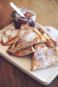 some pancakes and jam on a white plate