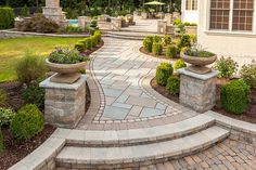 an outdoor walkway with stone steps and planters