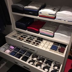 an organized closet with folded shirts, ties and other items in it's drawers