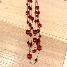 Never Worn Long Red Beaded 3 Strand Necklace. Red Long Beaded Necklaces For Party, Long Red Beaded Necklaces For Parties, Red Long Beaded Necklace For Party, Elegant Red Long Beaded Necklace, Elegant Long Red Beaded Necklace, Multi-strand Red Necklace With Colorful Beads, Multi-strand Red Jewelry For Party, Red Multi-strand Party Jewelry, Red Multi-strand Beaded Necklace