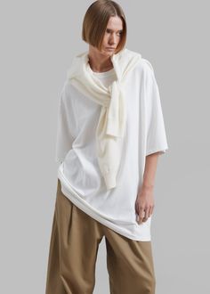 Color: White Midweight cotton jersey Oversized fit Crew neckline Drop shoulders Slip on style Unlined 100% Cotton Dry Clean Only By The Frankie Shop. Imported Oversized Casual T-shirt For Daywear, Classic Oversized T-shirt For Spring, Oversized Effortless T-shirt For Fall, Oversized White Fine Knit Tops, Effortless Oversized T-shirt For Layering, Oversized Fine Knit Crew Neck Top, Slouchy Short Sleeve Tops For Loungewear, Classic Oversized Tops For Everyday, White Fine Knit Top With Short Sleeves