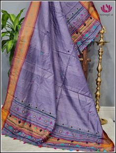 Beautiful Hand embroided Lambani Dupatta in purple Vidharba Tussar with solid orange border. The small floral embroided designs and colorful tassels at the end enhances the beauty of the dupatta more. Please note: Color may vary slightly from the picture. Thread pulls, knots and few thread gaps are common in this type of dupattas and is not a defect. Very minor stains from threads are normal for this type of hand embroided duand is not defect. Festive Purple Saree With Embroidered Border, Festive Purple Cotton Traditional Wear, Purple Traditional Wear With Embroidered Border, Purple Traditional Drape With Embroidered Border, Festive Embroidered Lavender Dupatta, Festive Embroidered Lavender Traditional Wear, Unstitched Embroidered Purple Saree, Unstitched Purple Embroidered Traditional Wear, Unstitched Purple Embroidered Saree