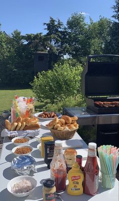 an outdoor bbq with food and drinks on it