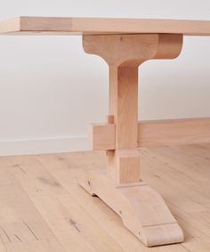 a wooden table sitting on top of a hard wood floor