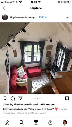 an aerial view of a living room with red couches and black curtains on the windows