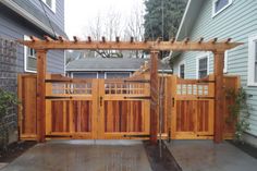 a wooden gate in front of a house