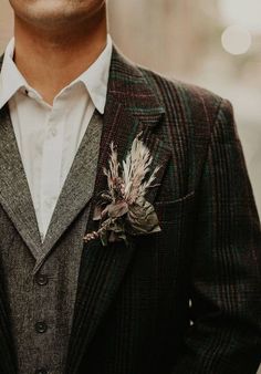 a man in a suit with a flower on his lapel