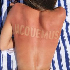 a woman with her back turned to the camera, has acnemus written on her back