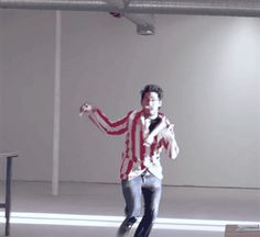 a man is dancing in an empty room