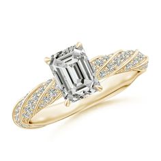 an emerald cut engagement ring with diamond accents on the shoulders and side stones in yellow gold