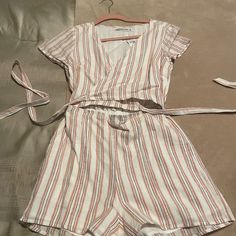 Up For Sale Is Brand New With Tag Abercrombie & Fitch Tie Front Striped Jumpsuit In Size Small. Colors Are Cream, Pink, Tan. Bottom Portion Of The Shorts Is Lined And Not See Through. Never Been Worn. Summer Pink Short Sleeve Jumpsuit, Pink Short Sleeve Summer Jumpsuit, Pink Matching Set Jumpsuits And Rompers For Spring, Chic Pink Jumpsuits And Rompers With Tie Waist, Chic Pink Jumpsuit With Tie Waist, Striped Jumpsuit, Abercrombie Fitch, Pant Jumpsuit, Jumpsuit Romper