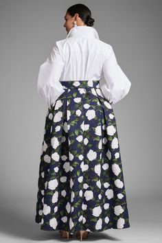 Florence is classic versatility at it's finest. Her top features a pearled button down silhouette in Indian cotton while the bottom is a navy, subtly pleated ball skirt with ivory printed peonies. The two are met in the middle with a printed belt for a flattering, waist-cinching look.Details:Model is 5'10" wearing size 2Full-Length, 60" from top of shoulder to bottom hemFront Button Closure Indian Cotton - Printed Poly Faille 100% PolyesterImportedStyle #S242G18-416 Elegant Voluminous Skirt For Garden Party, Elegant Full Skirt For Garden Party, Elegant Floral Print Skirt For Daywear, Elegant Floral Print Voluminous Skirt, Elegant Voluminous Floral Print Skirt, Elegant Floral Print Skirt For Formal Occasions, Elegant Formal Skirt With Floral Print, Elegant Fitted Skirt For Garden Party, Elegant Formal Floral Print Skirt