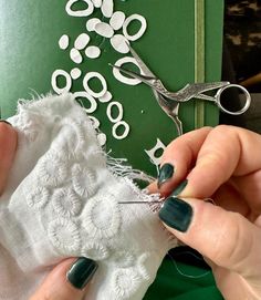 someone is using scissors to cut fabric