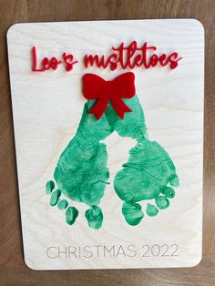 a handprinted christmas ornament on a wooden plaque