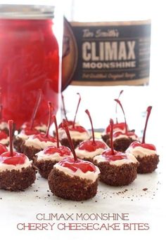 mini cheesecake bites are topped with cherry jam and marshmallows for a festive treat