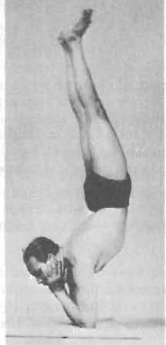 an old photo of a man doing a handstand