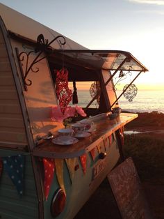 an old camper van is parked near the ocean