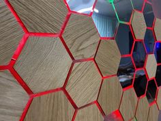 a wooden wall with red and green hexagonal tiles on it's sides