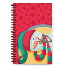 a spiral notebook with a snowman wearing a santa hat and scarf on it's head