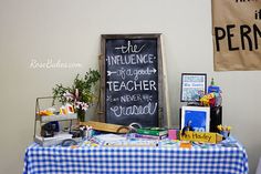 a blue and white checkered table cloth with a chalkboard sign on the wall