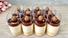 there are many small cups with chocolates in them on top of each other,