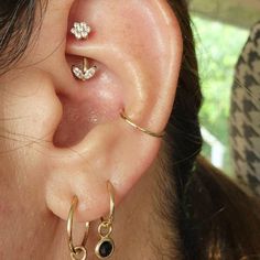 a close up of a person's ear with two different types of piercings