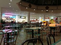 the inside of a restaurant with tables and chairs