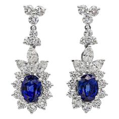 These beautiful earrings feature two natural blue sapphires weighing 3.72 carats total. These sapphires have a royal blue color and are eye clean. These sapphires are accented with 3.23 carats of brilliant diamonds. Set in 18k white gold. Has post. A timeless piece. Elegant Blue Gia Certified Diamond Earrings, Elegant Blue Oval Diamond Earrings, Formal Oval Sapphire Diamond Earrings, Formal Sapphire Diamond Oval Earrings, Classic Blue Oval Diamond Earrings, Sapphire Oval Earrings Brilliant Cut, Classic Oval Sapphire Diamond Earrings, Luxury Elegant Sapphire Earrings, Blue Sapphire Oval Diamond Earrings