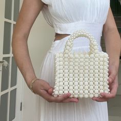 This handmade bridal clutch, designed to complete your elegance on special occasions, is meticulously crafted with durable twine cord and luxurious pearl beads. Each detail has been carefully chosen to not only offer sophistication but also to highlight your grace. - Material: High-quality durable twine cord and shiny pearl beads. - Dimensions: (Length x Height x Width) For example, 18 cm x 21 cm x 6 cm. - Details: Handcrafted with meticulous attention, each bead and cord embroidery is sewn by hand. - Usage:Perfectly complements bridal attire, adding an elegant touch to weddings and formal events. This clutch not only enhances your elegance but also provides durability and confidence for your special occasions. Handmade with care, each clutch is unique and special. Note: For color or size Cord Embroidery, Pearl Clutch Bag, Bead Accessories, Pearl Clutch, Bridal Attire, Wedding Handbag, Wedding Purse, Bridal Clutch, Pearl Bag