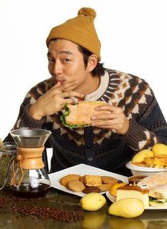 a man sitting at a table with food in front of him