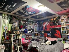 a bed room with a neatly made bed and lots of posters on the wall above it