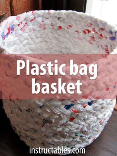 a plastic bag basket sitting on top of a wooden table next to a window with the words, plastic bag basket