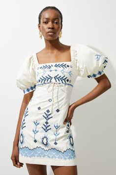 Crafted With Contrasting Embroidery Motifs, This Piece Goes Seamlessly From Day To Night, A True Summer Staple. It Features A Square Neckline That Accentuates The Bust And Embroidery Adornes The Entire Garment. Complete With Puffed Sleeves, This Piece Can Be Easily Styled With Sandals Or Strappy Heels For A Summer Look To Keep Reaching For. Cotton Embroidered Puff Sleeve Woven Mini Dress High Quality Cotton Fabric Contrasting Embroidered Details Flattering Straight Fit Sophisticated Square Neckl Blue And White Sundress, Modest Cute Dresses, Long Church Dresses, Senior Picture Dresses, European Fashion Aesthetic, Blue Puff Sleeve Dress, Hen Do Outfits, White And Blue Dress, Workwear Capsule Wardrobe