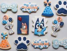 decorated cookies are arranged in the shape of dogs and birthday hats for children to enjoy