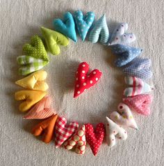 many different types of fabric bows arranged in the shape of a circle on a white surface