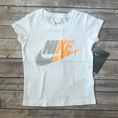 Nwt She Will Always Be In Style With Eye-Catching Design In This Nike Graphic Tee. *Color - White *Crewneck *Textured Nike Graphic At Front *Machine Washable *100% Cotton The Color May Appear A Bit Different Due To Lighting And Screen Resolution. Reasonable Offers Are Welcome. Bundle To Save!!! Nike Orange Crew Neck T-shirt, Nike Casual Orange Tops, Casual Nike Orange Tops, Casual Orange Nike Tops, Orange Cotton Tops With Logo Print, Nike Orange Short Sleeve Tops, Cute Nike White Tops, Cute White Nike Top, Graphic Tees Girls