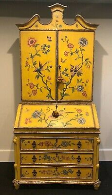 an old yellow painted dresser with flowers and birds on it