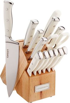 an assortment of kitchen knives in a wooden holder