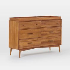 a wooden dresser with six drawers and one drawer on the bottom, in front of a white background