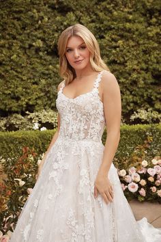 a woman in a wedding dress posing for the camera